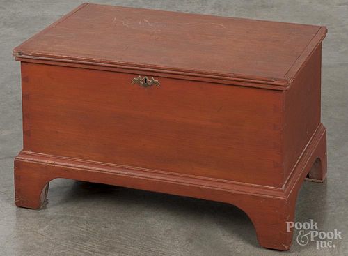 Miniature stained poplar blanket chest, 19th c., retaining a later red surface, 14'' h., 23'' w.