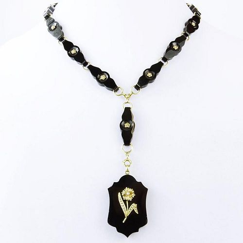 Circa 1890 Victorian 14 Karat Yellow Gold. Black Onyx and Seed Pearl Pendant Necklace. Unsigned. Good condition. Measures 19" L. Pendant drop 4-1/4" L