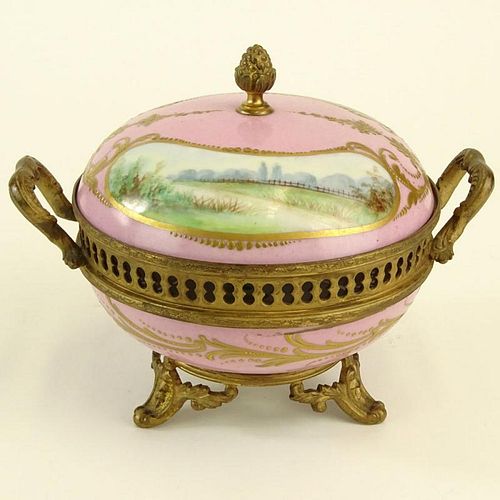 Sevres Bronze Mounted Hand Painted Covered Porcelain Box. Marked on bottom. Light wear or in good condition. Measures 6" H x 5-1/4" Dia. Shipping $65.
