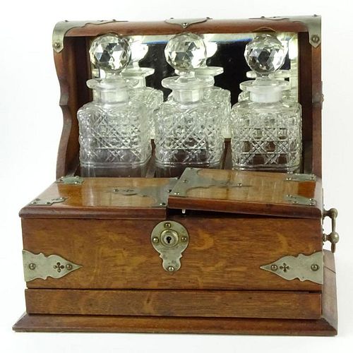 19th Century Bronze Mounted Oak Tantalus with Cut Glass Decanters. Unsigned. Rubbing to bronze mounts, cloudy decanters, no key (locked door) otherwis
