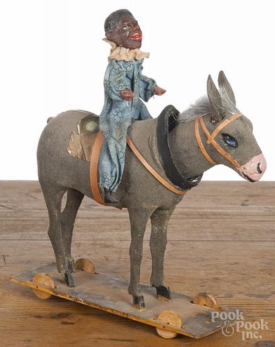 Black Americana man riding a donkey pull toy, 19th c., with a nodding head, 9 3/4'' h.