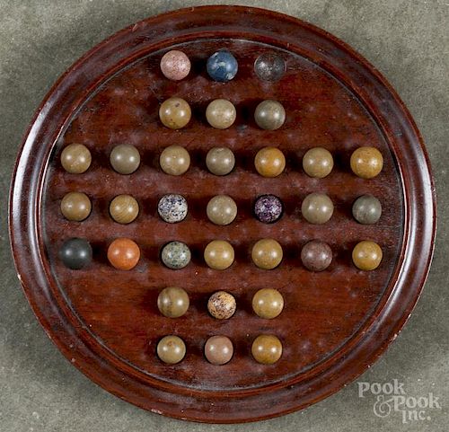 Walnut marble game, 19th c., with clay marbles, 8 1/2'' dia.