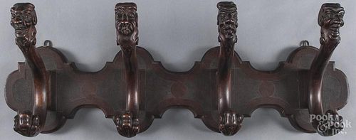 Carved mahogany coat rack, late 19th c., with figural hangers, 10 1/2'' h., 31 3/4'' w.