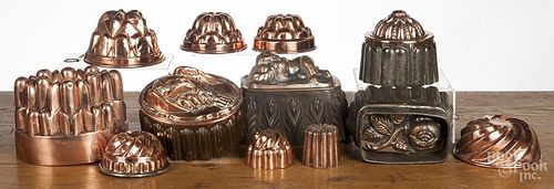 Twelve copper and tin food molds.