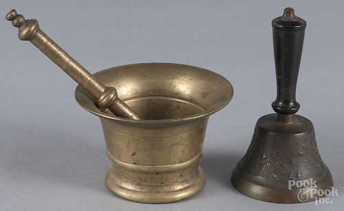Brass mortar and pestle, 19th c., 3 1/4'' h., together with an embossed brass hand bell