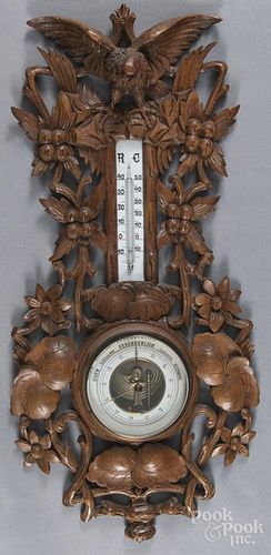 Black Forest carved barometer/thermometer, 20th c., with an eagle crest, 28'' h.
