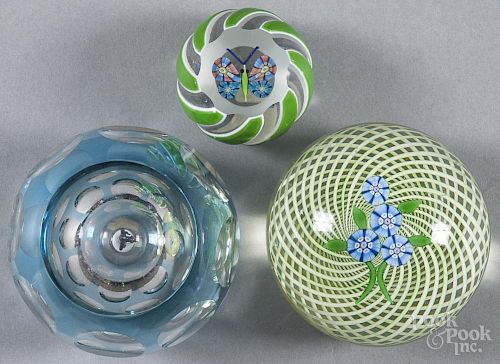 Three Perthshire glass paperweights, to include one with flowers on a latticino ground, marked