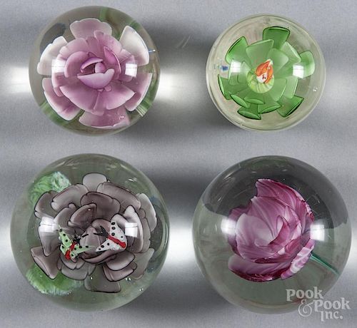 Four floral art glass paperweights, largest - 3 1/2'' dia.