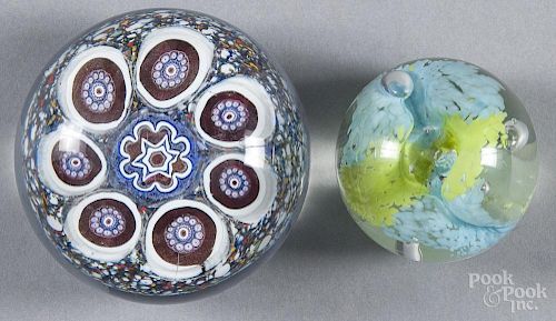Two signed and dated art glass paperweights, to include a 1975 example with a central flower