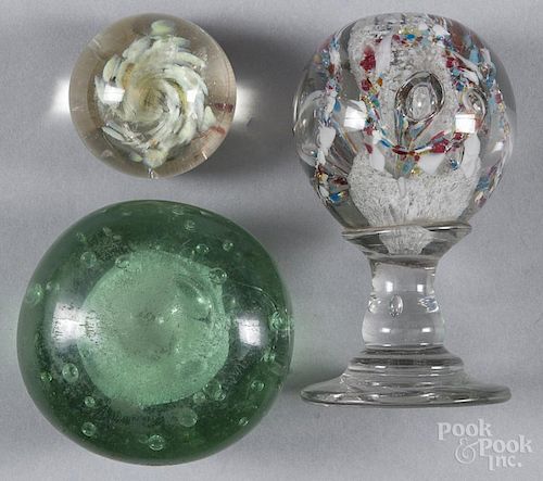 Three glass paperweights, to include a pedestal base example, 6'' h., 3'' dia.