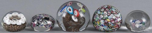 Three floral millefiori glass paperweights, together with two antique scramble glass paperweights