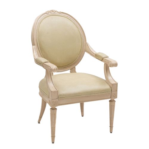 Sillón. SXX. Estilo Luis XVI. Elaborado en madera entintada. Con respaldo y asiento en vinipiel color beige.