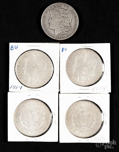 Five Morgan silver dollars, to include a 1904, VG, and four 1904 O, VF-XF.