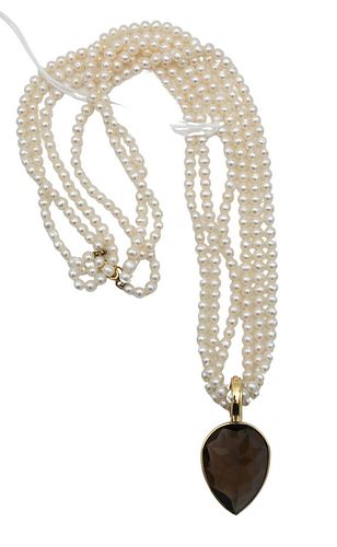 Pearl Triple Strand Necklace, having 14 karat gold clasp and 14 karat gold pendant mounted with pear shaped brown stone.