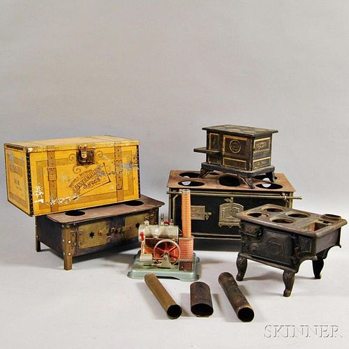 Four Miniature Stoves, a Steam Engine, and an Advertising Tin