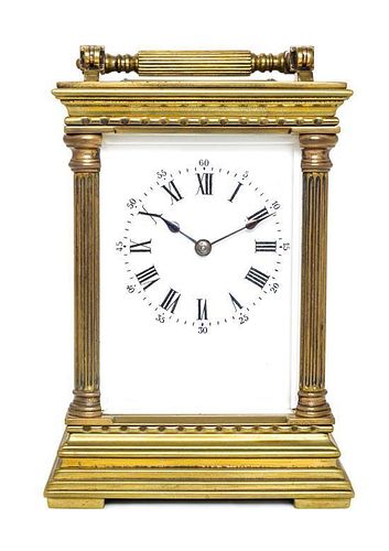* A French Brass and Glass Carriage Clock Height over handle 8 inches.