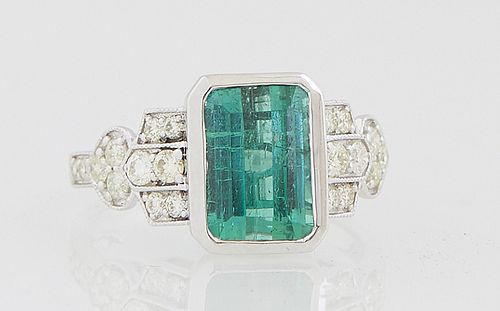 Lady's 18K White Gold Dinner Ring, with a 3.51 ct. emerald cut green tourmaline, flanked by diamond mounted lugs and shoulders of the band, total diam