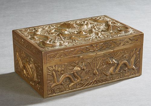 Chinese Bronze Dresser Box, 20th c., with relief decoration of dragons, and a mahogany lined interior, H.- 3 1/4 in., W.- 7 1/4 in., D.- 5 in. Provena