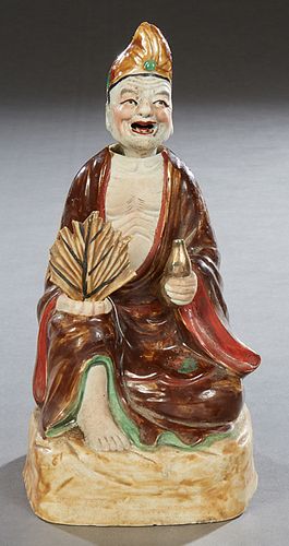 Oriental Figural Male Nodder, early 20th c., of a seated man drinking from a bottle, originally mounted as a lamp, H.- 9 3/4 in., W.- 4 1/2 in., D.- 4
