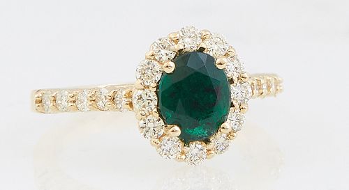Lady's 18K Yellow Gold Dinner Ring, with an oval 1.24 ct. emerald atop a border of round diamonds, the shoulders of the band also mounted with round d