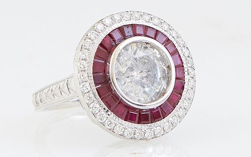 Lady's 18K White Gold Dinner Ring, with a central round 2.5 carat diamond within a border of princess cut rubies and an outer border of round diamonds