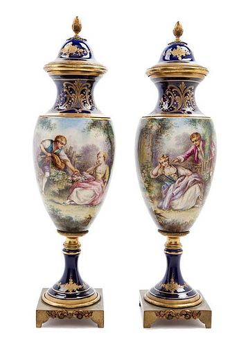 A Pair of Sevres Style Porcelain Urns Height 14 1/2 inches.