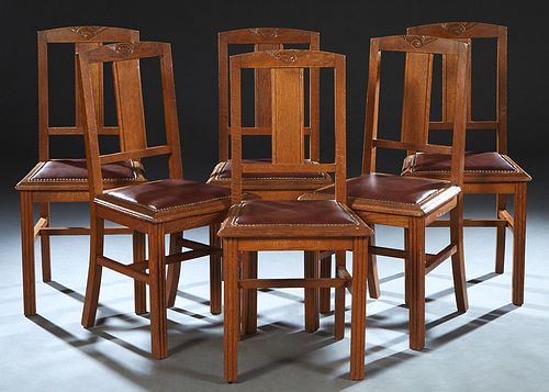 Set of Six French Art Deco Carved Oak Dining Chairs, c. 1940, the arched crest rail with a geometric floral carving, over a vertical back splat, to a 