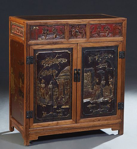 Chinese Lacquered and Carved Elm Sideboard, early 20th c., with a red figural and landscape lacquered top over three frieze drawers with relief figura