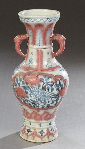 Chinese Blue and Red Porcelain Baluster Vase, 20th c., the everted rim over a neck with elephant head ring handles, above sides with floral and bird d