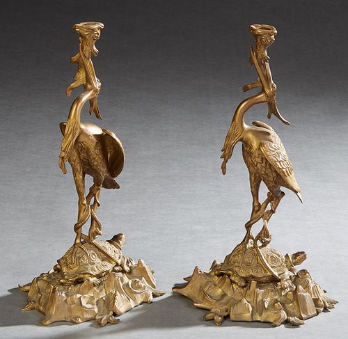 Pair of Oriental Brass Crane Candlesticks, early 20th c., the crane standing on a turtle, upholding a fish, now lacking the candlecups, H.- 12 1/2 in.