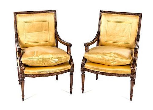 A Pair of Louis XVI Style Walnut Fauteuils Height 36 inches.
