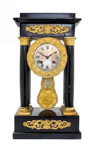 * An Empire Gilt Metal Mounted Ebonized Portico Clock Height 15 inches.