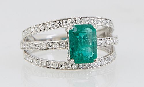Lady's Platinum Dinner Ring, with a 1.65 carat emerald atop three pierced bands mounted with small round diamonds, total diamond wt.- .6 cts., Size 6 