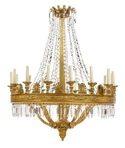 A Neoclassical Giltwood Sixteen-Light Chandelier Height 58 x diameter 41 inches.