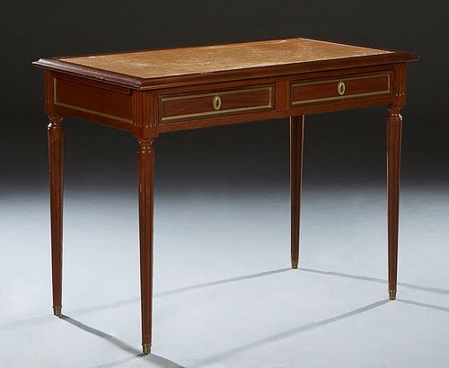 French Louis XVI Style Ormolu Mounted Carved Cherry Writing Table, early 20th c., the ogee edge rectangular top with an inset gilt tooled leather writ
