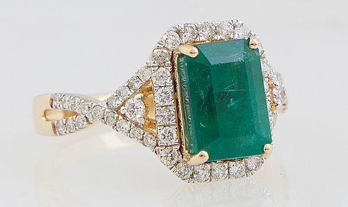 Lady's 18K Yellow Gold Dinner Ring, with a 3.05 ct. emerald atop an octagonal border of small round diamonds, the pierced lugs and shoulders of the ba