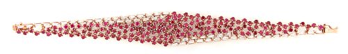 Unusual 14K Rose Gold Link Bracelet, of tapering form, the center with 153 round rubies, flanked on one side of the top and bottom with 50 tapered bag