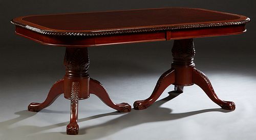 Inlaid and Banded Carved Mahogany Dining Table, 20th c., with a gadrooned edge, on double urn form pedestals on tripodal paw feet, with two leaves, H.