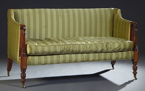 English Sheraton Style Carved Mahogany Settee, 19th c., the rctangular upholstered back, over upholstered arms, over a removable cushion seat, on turn