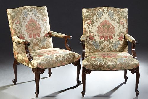 Pair of Carved Mahogany Fauteuils, early 20th c., the canted arched cushioned back to upholstered arms and a bowed upholstered seat, on scrolled cabri
