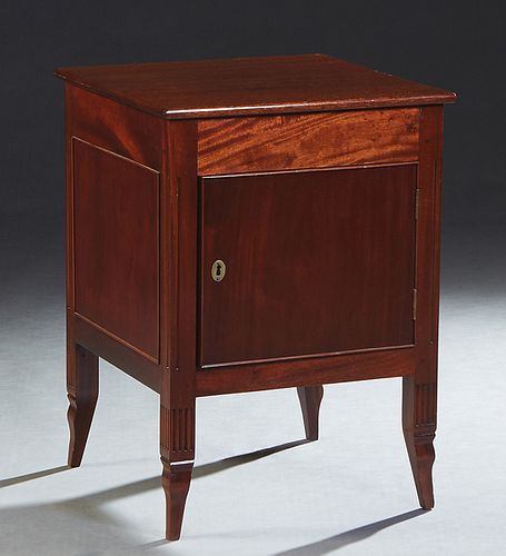 French Louis XV Style Carved Mahogany Nightstand, late 19th c., the square top over a frieze drawer and a large cupboard door, on reeded tapered squar