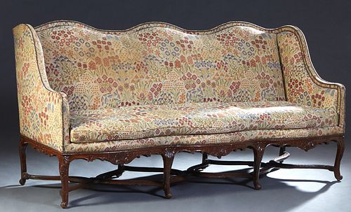Large French Louis XV Style Carved Mahogany Settee, 19th c., the serpentine back flanked by sloping upholstered arms, to a seat with a removable cushi