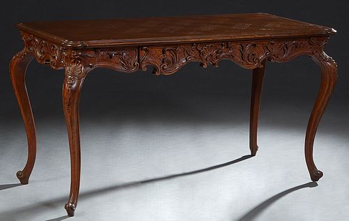 Louis XV Style Carved Oak and Walnut Writing Table, 20th c., the stepped cookie corner parquetry inlaid oak top over a large frieze drawer on one long