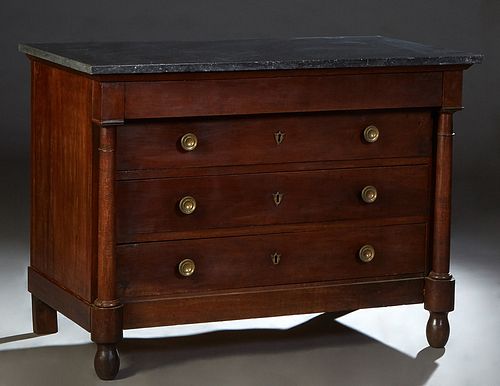 French Empire Style Carved Walnut Marble Top Commode, 19th c., the figured black marble over a frieze drawer above three setback deep drawers, flanked