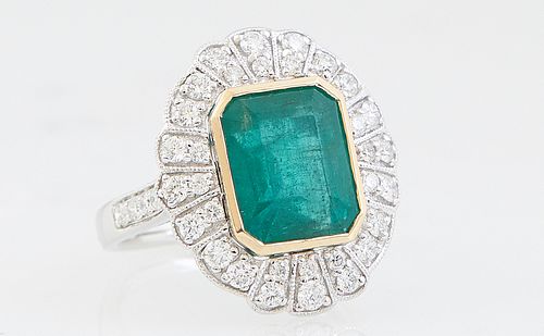 Lady's 14K White Gold Dinner Ring, with a 4.58 ct. emerald atop an oval floriform border mounted with two rows of graduated round diamonds, the should