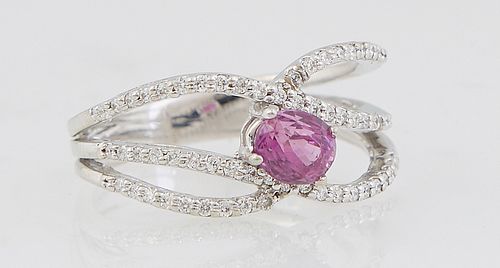 Lady's 14K White Gold Dinner Ring, with an oval .78 ct. pink sapphire, atop triple split swirled bands mounted with tiny white diamonds, total diamond