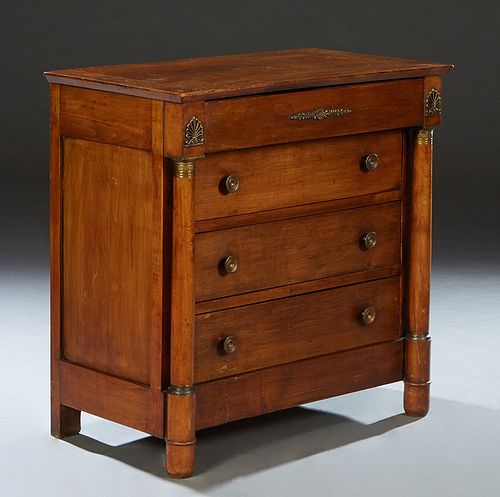 French Empire Style Carved Cherry Commode, early 20th c., the rectangular top over a frieze drawer and three setback deep drawers, flanked by tapered 