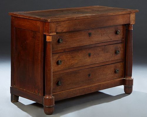 French Empire Style Carved Walnut Commode, 19th c., the rectangular top over a setback frieze drawer and three deep drawers, flanked by turned tapered