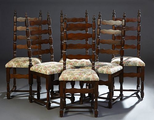 Set of Six French Provincial Carved Oak Dinng Chairs, 20th c., the canted ladder back over a trapezoidal cushioned seat, on turned and block legs join