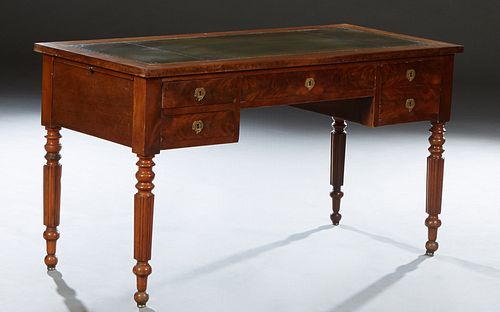 French Louis Philippe Style Carved Walnut Desk, early 20th c., the rectangular top with an inset gilt tooled green leather writing surface, over a cen